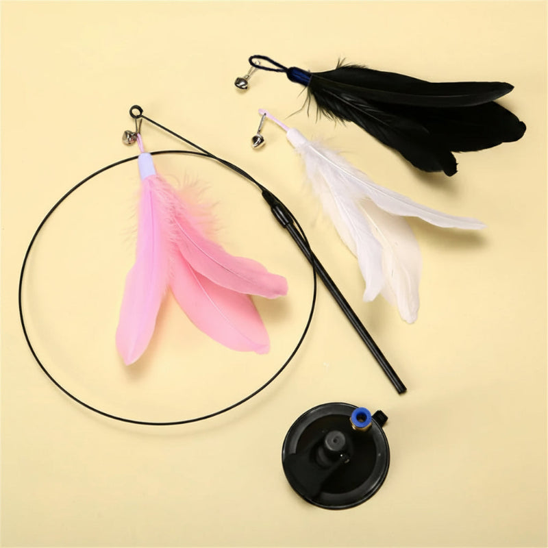 Cat toy with feathers and a black base on a beige background